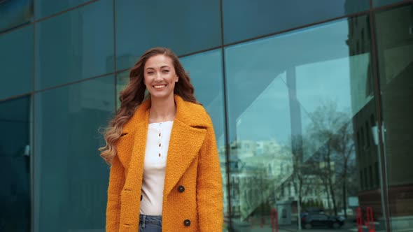 Business Woman with Shopping Bags Dressed Yellow Coat Walking Outdoors Corporative Building alt