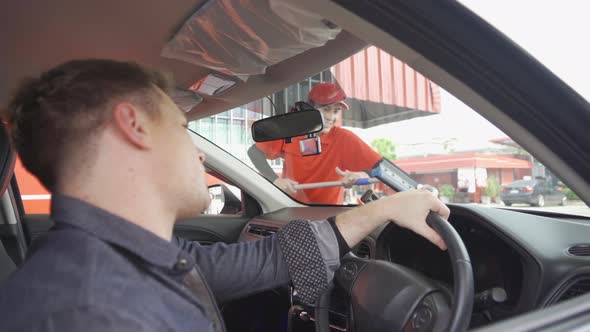 Washing car windshield by gas station worker cleaning a car glass, service at gasoline alt