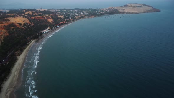 Tropical beach and fishing boats harbour in Hon Rom bay, Vietnam, aerial view alt