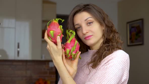 Young Girl is Holding Two Fresh Ripe Organic Dragon Fruits or Pitaya Pitahaya alt