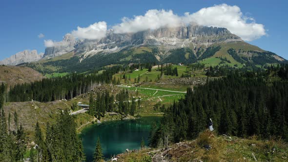 Women on Top of Hill with Uprooted Pine Trees After Strong Wind in Lake Carezza Most Beautiful Lakes alt