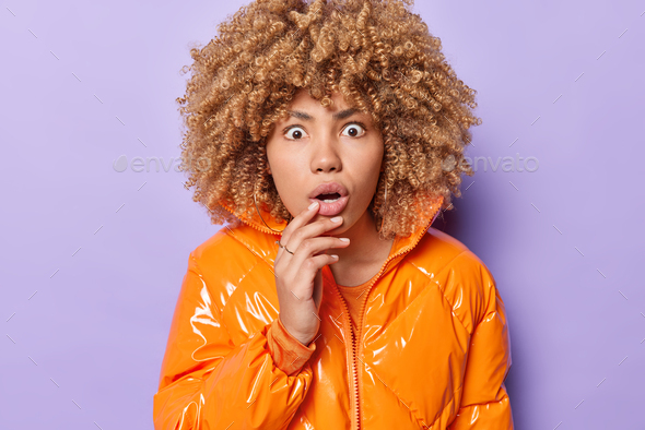 Shocked Stunned Curly Haired Young European Woman Stares Surprised Sees