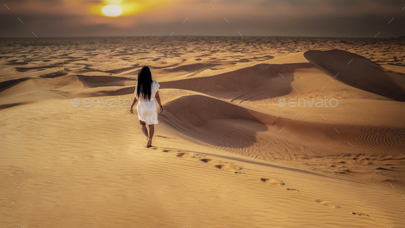 Dubai dessert sand dunes, Asian women on Dubai desert safari,United Arab Emirates