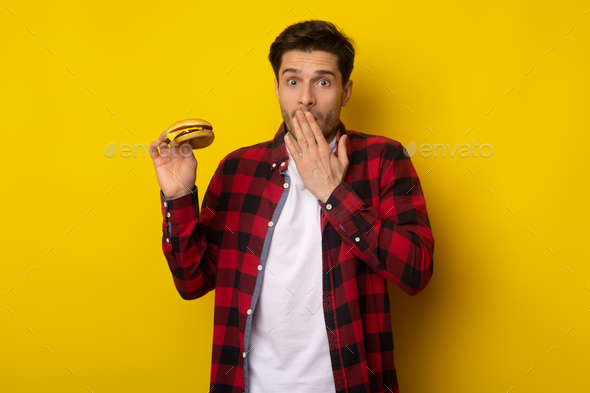 Funny Guy Holding Burger And Covering Mouth