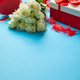 Bouquet of white roses with red bow on blue background. Boxed gift on side - PhotoDune Item for Sale