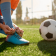 Soccer ball on grass and children football team training - PhotoDune Item for Sale