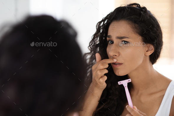 Face Hair Depilation. Woman Holding Razor In Hand And Touching Upper Lip