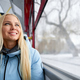 Pretty, blonde woman with long hair sitting on bus, waiting, looking through window. - PhotoDune Item for Sale