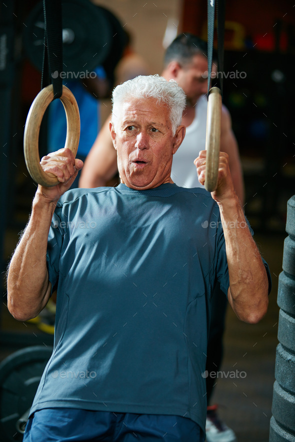 Hes still as fit as a fiddle. Cropped shot of a senior man working out in the gym. - Stock Photo - Images