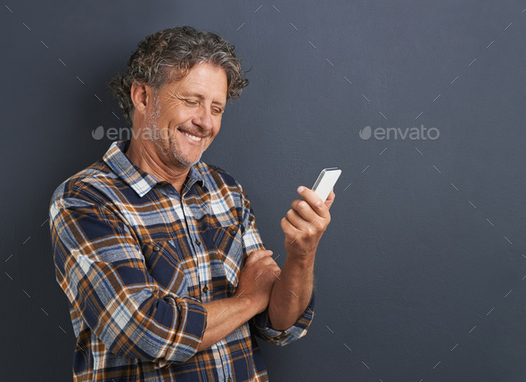 Who said old dogs cant learn new tricks. A cropped shot of a happy mature man using his smartphone.