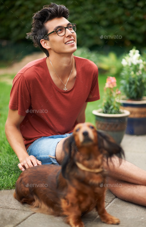 Mans best friend. Young guy hanging out with his dog outdoors.