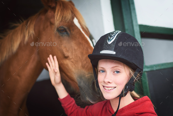 My happy place is at the stables. Shot of a teenage girl bonding with her horse.