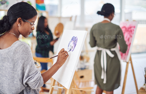 Enjoying another art session. Defocused shot of a group of people painting in a art studio.