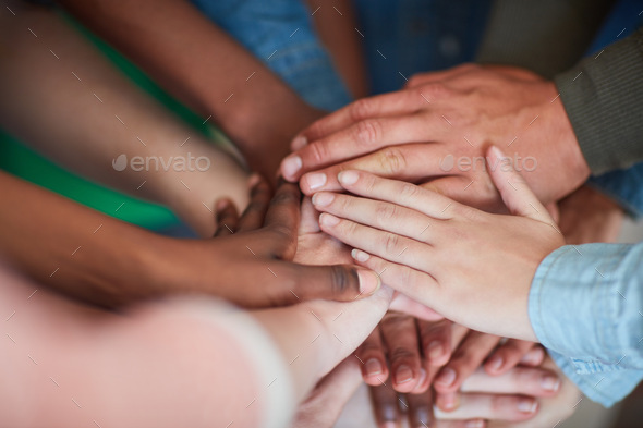 Teamwork will get it done. High angle shot of university students hands in a huddle.