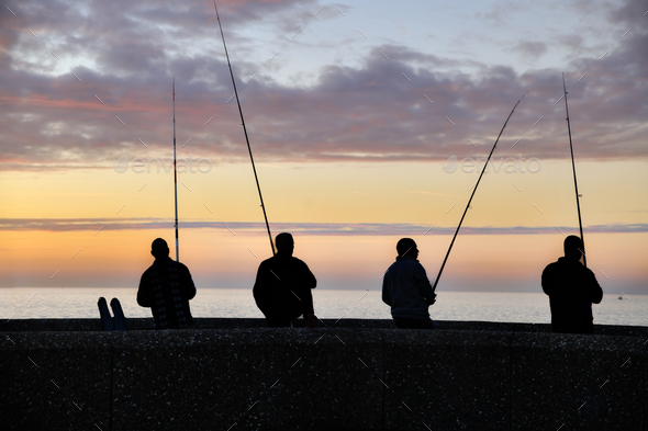 Fishermen fishing at a vanilla sunset on the Atlantic Ocean Stock Photo by  o1559kip