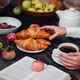 autumn flat lay female hands with coffee, apples, croissants, plums and book. - PhotoDune Item for Sale