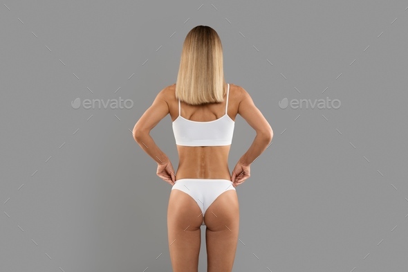 Young woman standing in top and underpants, hand pulling on underwear, rear  view - Stock Photo - Masterfile - Premium Royalty-Free, Code: 632-07161321