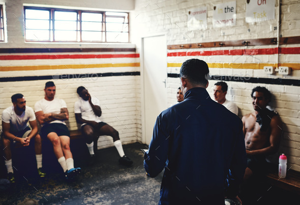 Cropped shot of a rugby coach addressing his team players in a locker room during the day