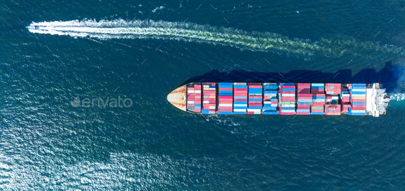 Pilot boat running near cargo maritime ship with contrail in the ocean ship carrying containe