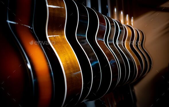 Row of guitars in a dim lighting