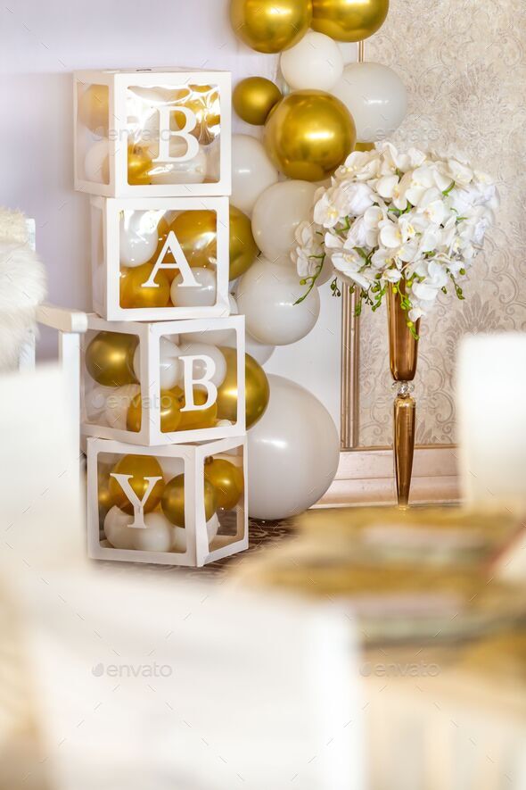 Vertical shot baby gender reveal party decorations with boxes with white  and gold balloons Stock Photo by wirestock