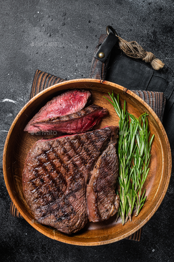 BBQ Grilled Medium Rare top sirloin beef steak, rump steak in a wooden