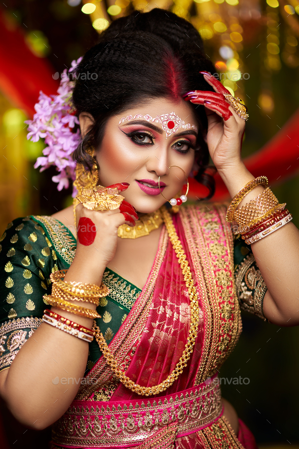 Closeup of a very beautiful young Indian bride in luxurious bridal costume with makeup