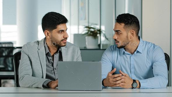 Confident arabic male financial consultant adviser expert talking to indian client customer explain - Stock Photo - Images