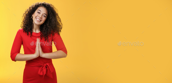 Welcome come inside. Portrait of friendly and polite good-looking female host in red dress with