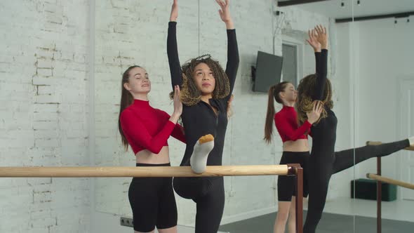 Personal Trainer Assisting Female in Body Stretching alt