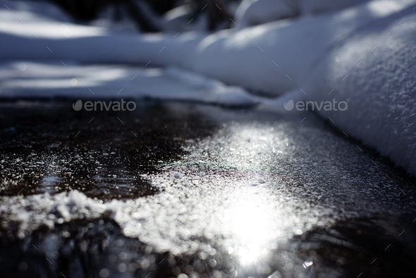 the sun is reflected in a frozen river on a winter day - Stock Photo - Images
