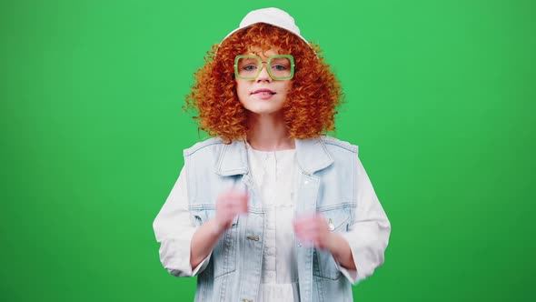 Young Awaiting Redhead Woman Looking at Camera with Expectation Seeing Great News and Dancing Chroma alt