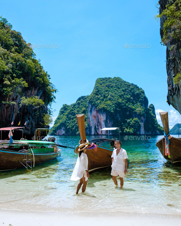 couple visit Koh Lao Lading near Koh Hong Krabi Thailand, beautiful beach with longtail boats - Stock Photo - Images