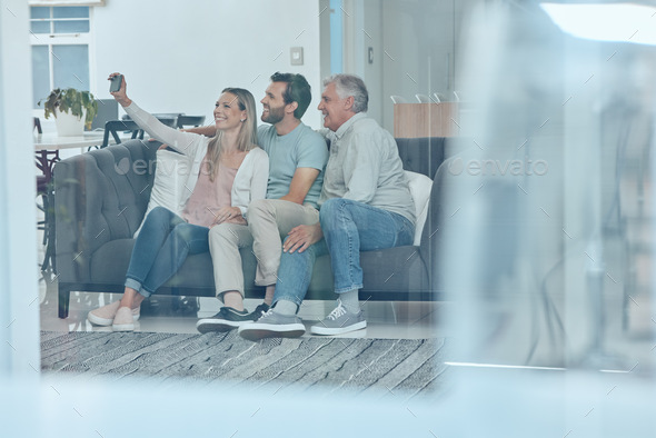 Selfie, phone and happy family on a sofa in the living room relaxing and bonding in their modern ho - Stock Photo - Images