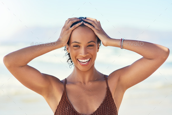I go gaga for sunny days. Cropped shot of a beautiful young woman spending the day at the beach. - Stock Photo - Images