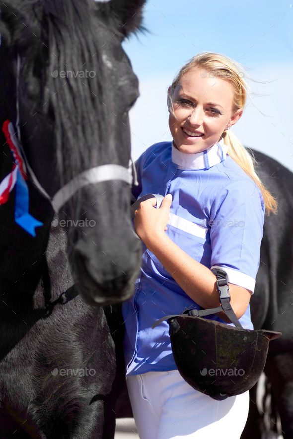 Hes more than just an animal to me. Shot of a beautiful young woman standing next to her horse.