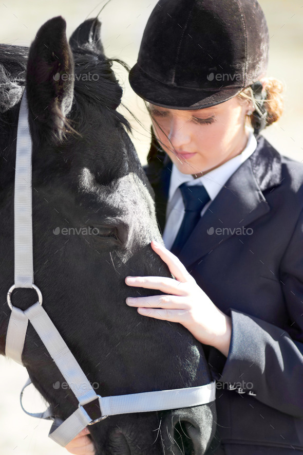 Hes more than just an animal to me. Shot of a beautiful young woman  standing next to her horse. Stock Photo by YuriArcursPeopleimages