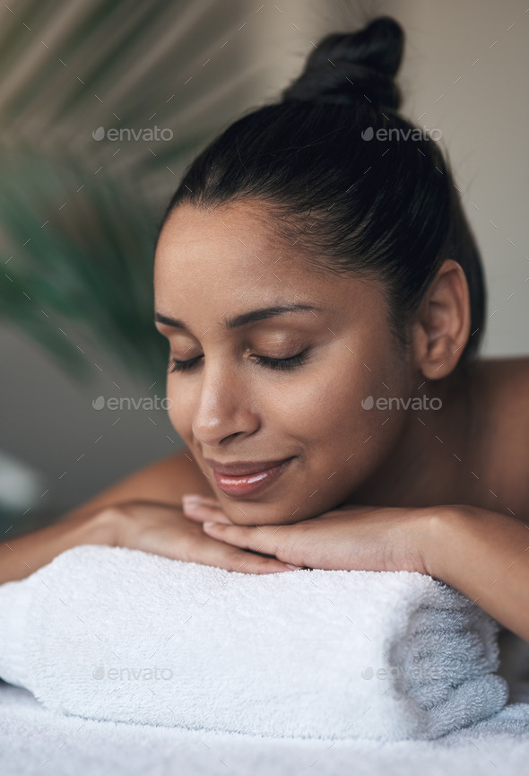 Rest well and your energy will be restored. Shot of a young woman lying ...