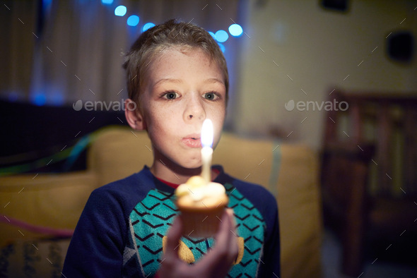 My birthday is only getting started. Shot of a little boy celebrating his birthday at night time.