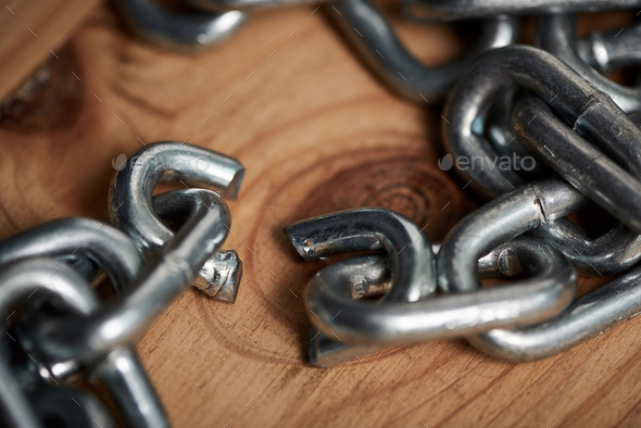 Sometimes you just have to let go. Shot of metal chains with a broken link.