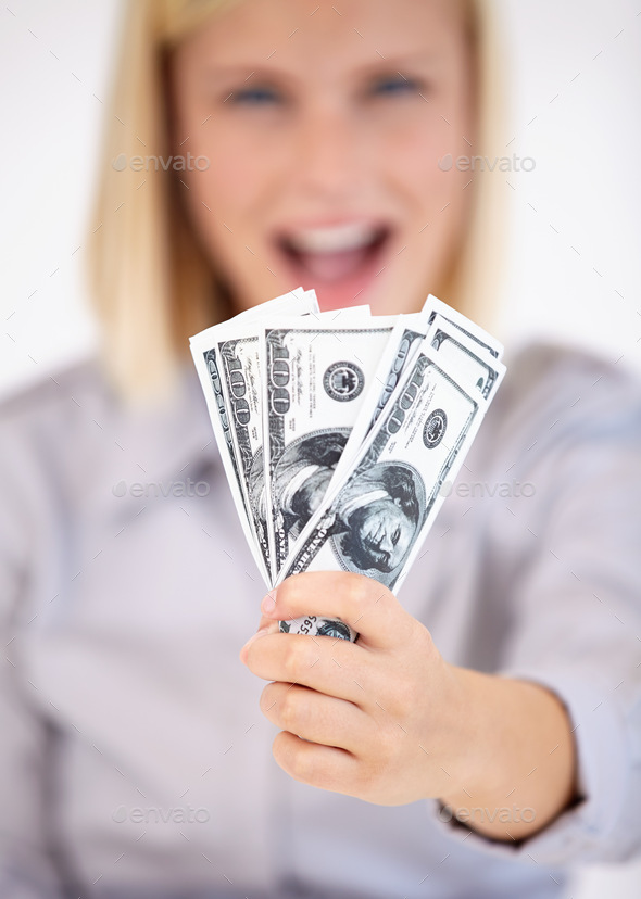 Hard-earned cash. A young woman showing you a wad of cash excitedly.