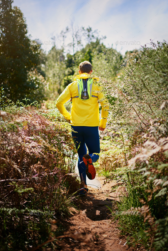 Run fast, run far, enjoy the view. Shot of a young man running along a nature trail.