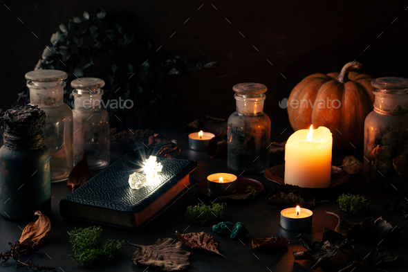 Witchcraft still life concept with potions, spell book, herbs ingredients candles magical equipment
