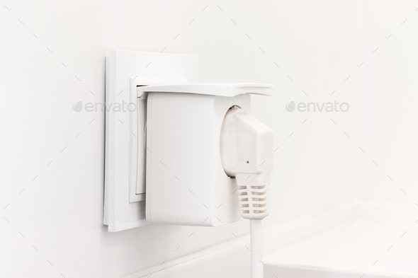 Electrical outlet with smart plug on modern bright bathroom