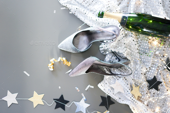 Formal evening wear silver high heels and glittery dress laying on the grey background. - Stock Photo - Images