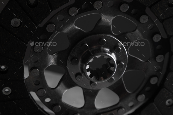 Close-up picture of a part of car, black clutch disk isolated on black background