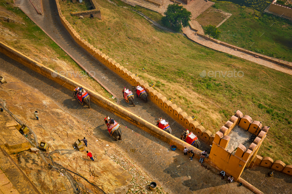 Tourists riding elephants on ascend to Amer fort - Stock Photo - Images