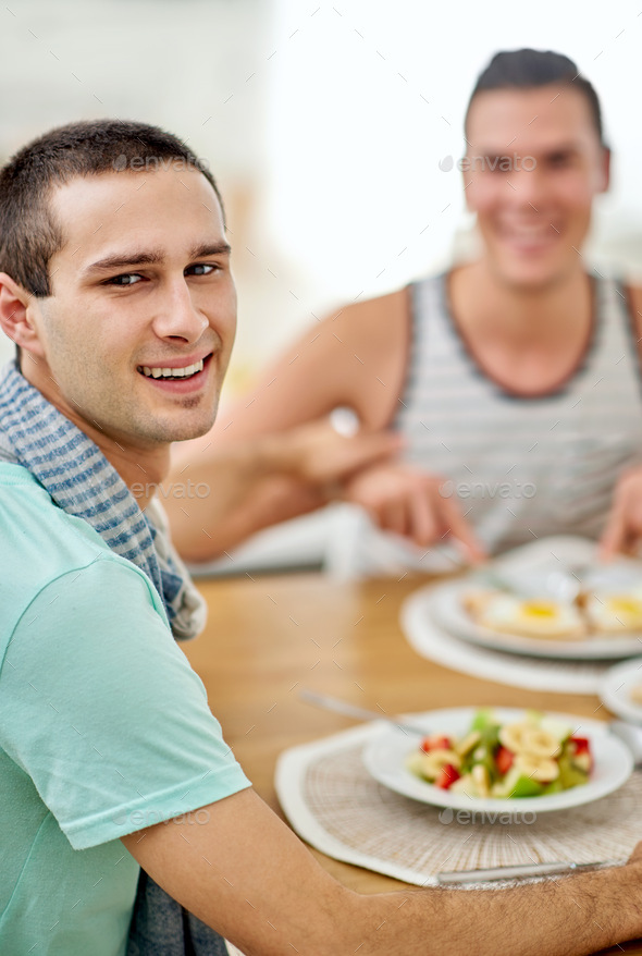 Couple who eat together, stay together. Portrait of a gay couple having lunch together.