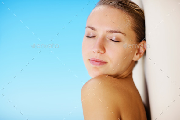 Elegant Topless Woman Leaning Against The Wall With The Blue Sky As The