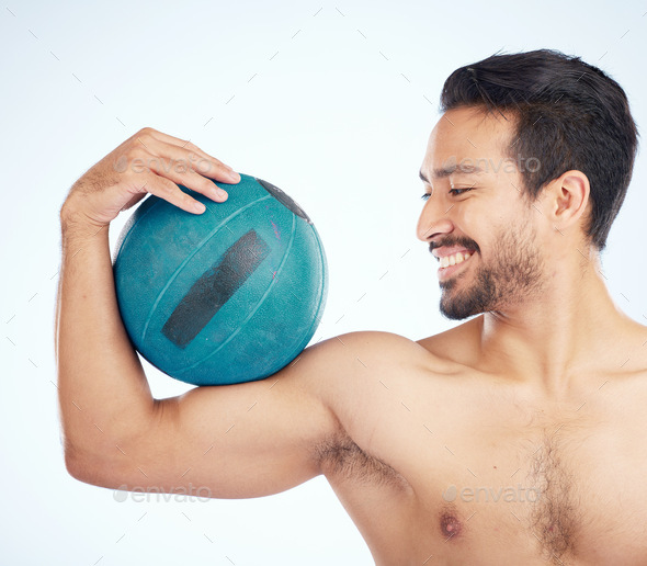 Face, fitness and man with medicine ball for exercise and health in studio on a blue background. Sp